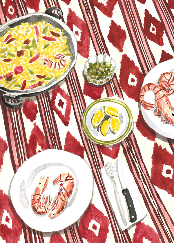 Kitchen art: paella and prawns on a patterned tablecloth