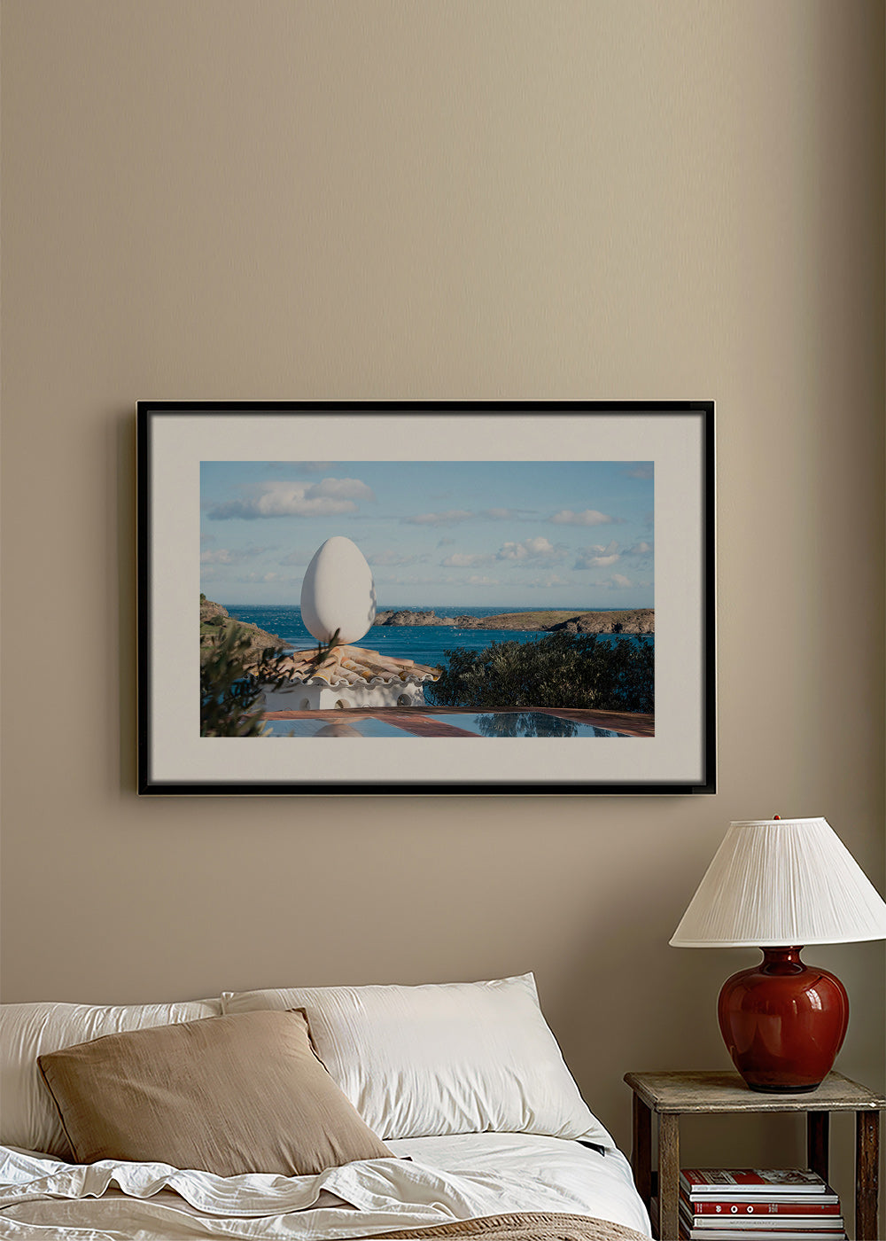 Landscape art featuring an egg sculpture by the sea