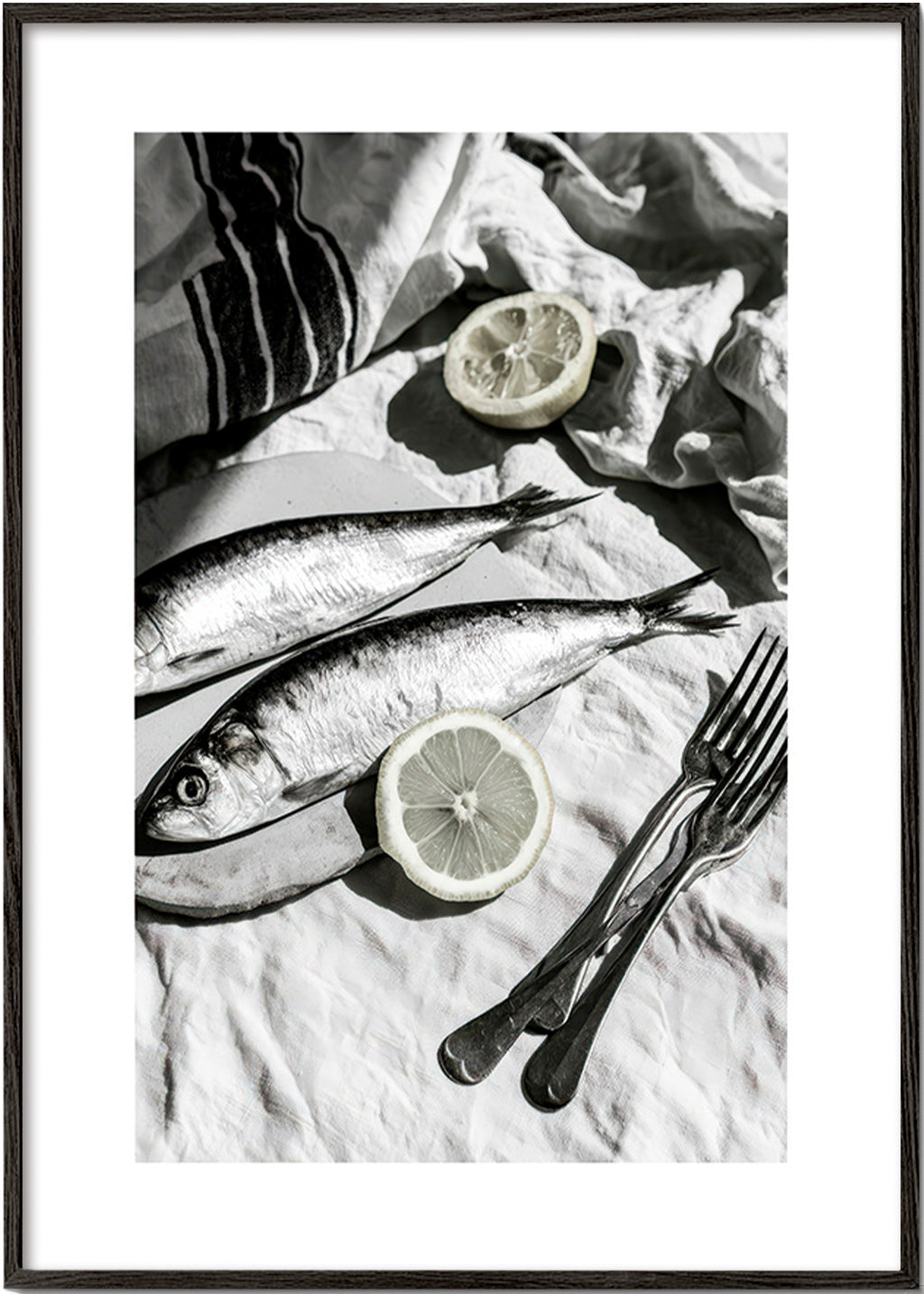 Kitchen art: monochrome sardines and lemon still life