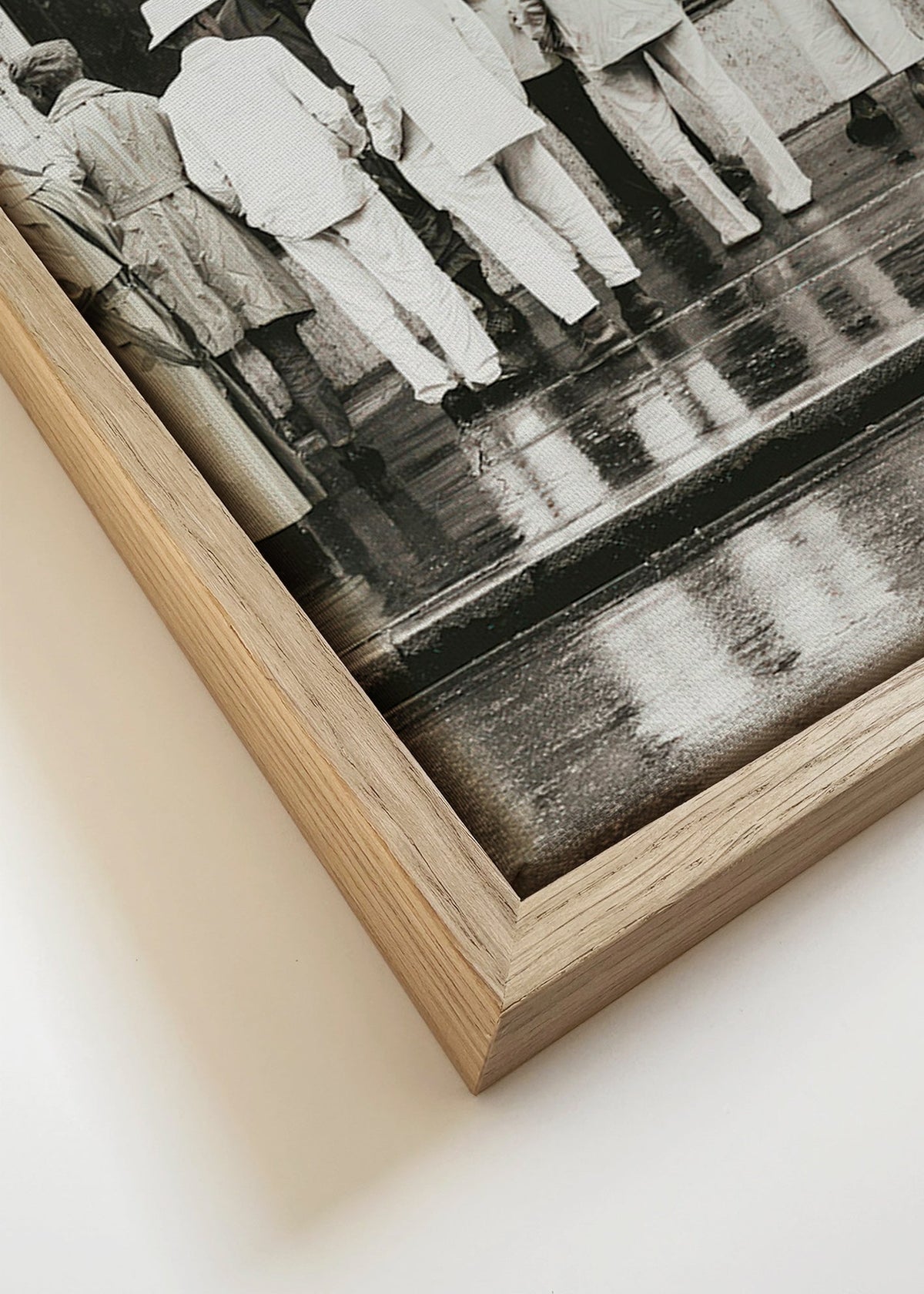 Black and white photo of men from the back in rain