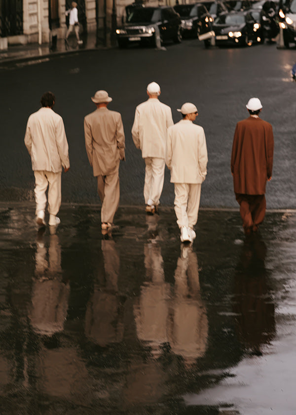 Photograph: five figures walking on a wet street