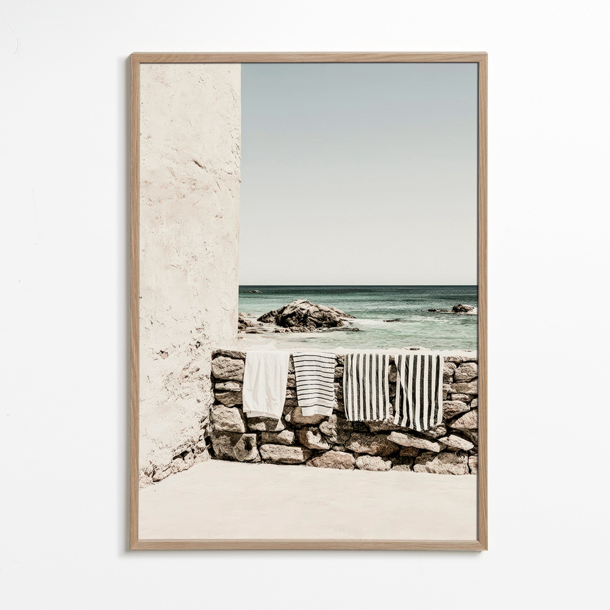 Coastal landscape photograph with hanging towels