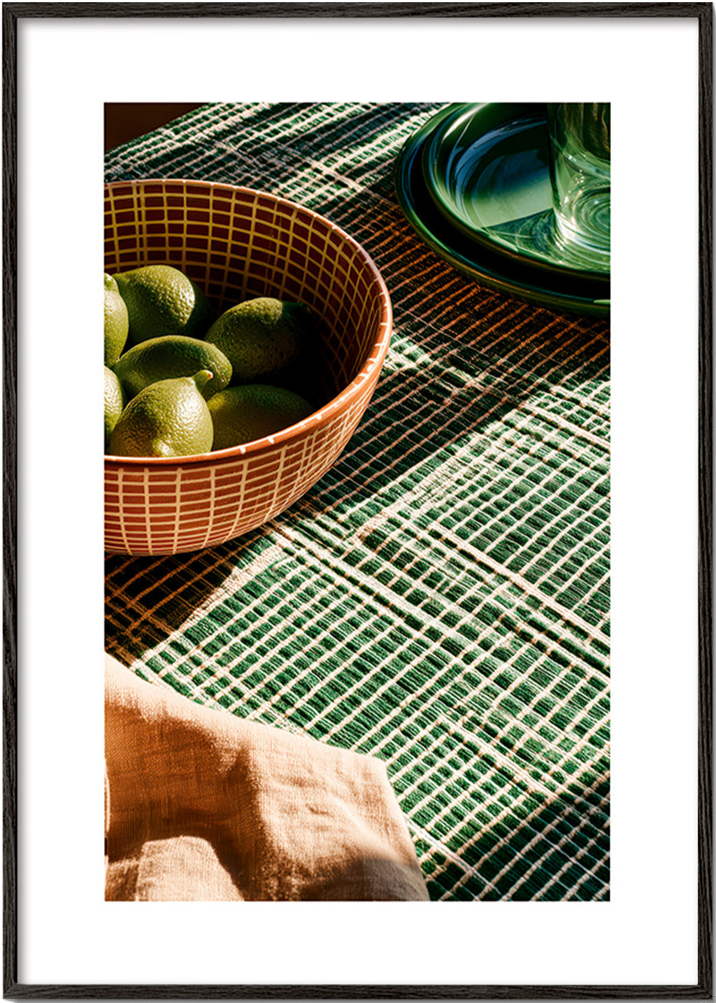 Kitchen art with limes in bowl and graphic cloth