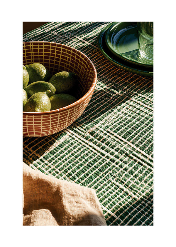 Kitchen art with limes in bowl and graphic cloth